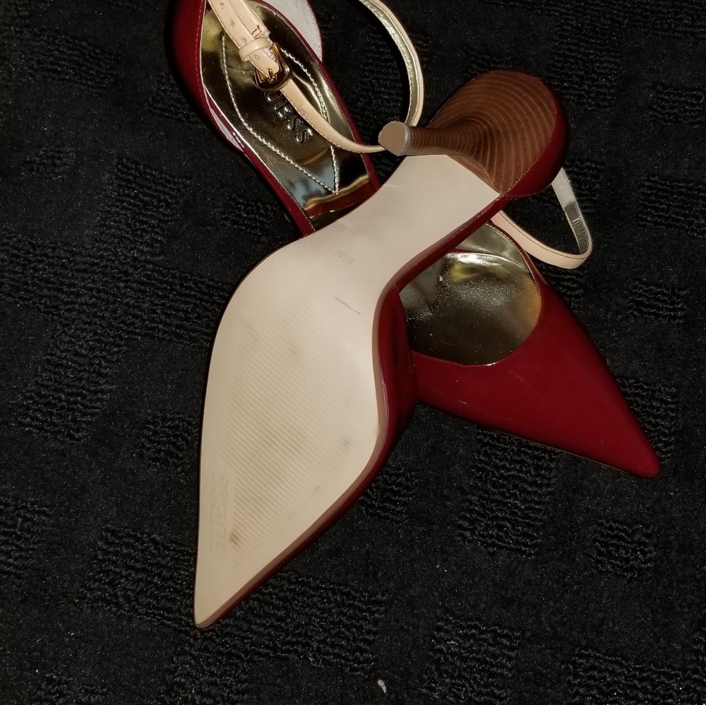 Women Guess ankle strap high heels.
